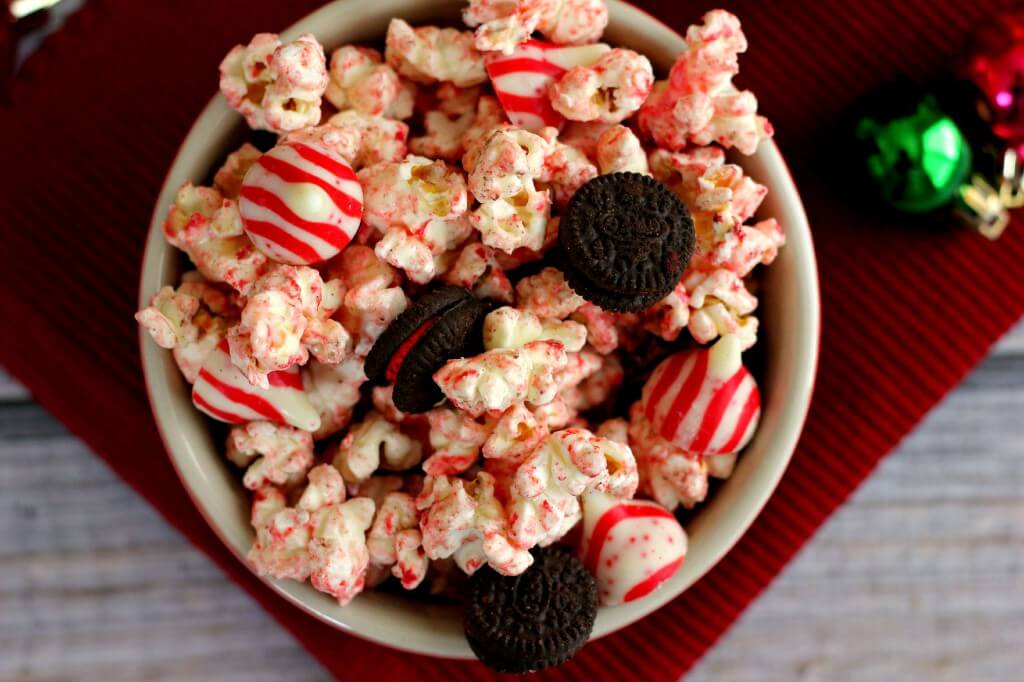 This White Chocolate Candy Cane Popcorn is coated with white chocolate and tossed with candy cane Oreos and candy cane kisses to provide a tasty snack.