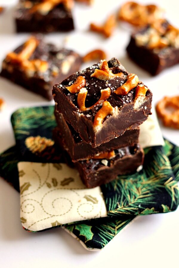 This Salted Dark Chocolate Pretzel Fudge combines smooth, rich chocolate, topped with buttery pretzels and a sprinkling of sea salt! #fudge #darkchocolate #darkchocolatefudge #pretzelrecipe #pretzelfudge #holidaydessert #holidayfudge #christmasdessert #christmasfudge #dessert