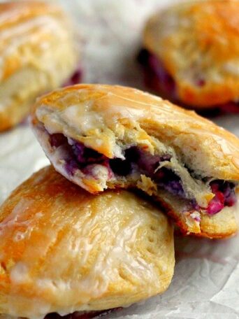 Light, fluffy, and bursting with a creamy fruit center, these Berry Cream Cheese Turnovers are perfect for breakfast, a mid-morning snack, or dessert!