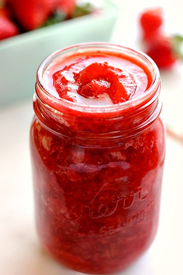 zoomed in view of a jar of strawberry sauce