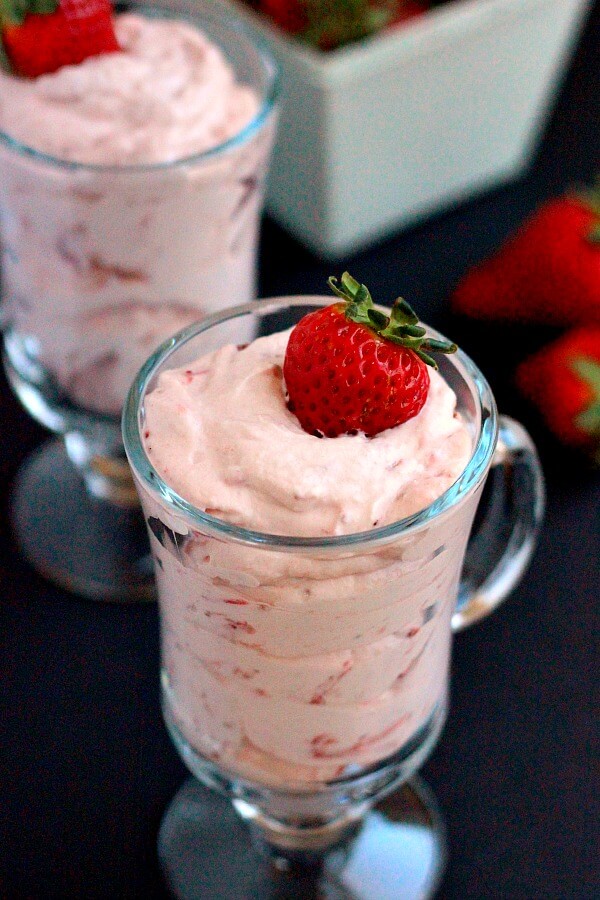 This Strawberry Mousse is a smooth and creamy dessert that is made with just four simple ingredients. Topped with a fresh strawberry this light and easy dessert is a delicious treat! #strawberryrecipes #strawberrydessert #strawberrymousse #pumpkinnspice #lightdessert