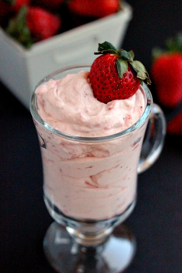 This Strawberry Mousse is a smooth and creamy dessert that is made with just four simple ingredients. Topped with a fresh strawberry this light and easy dessert is a delicious treat! #strawberryrecipes #strawberrydessert #strawberrymousse #pumpkinnspice #lightdessert