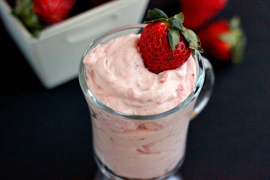 This Strawberry Mousse is a smooth and creamy dessert that is made with just four simple ingredients. Topped with a fresh strawberry this light and easy dessert is a delicious treat! #strawberryrecipes #strawberrydessert #strawberrymousse #pumpkinnspice #lightdessert