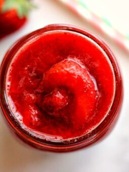 top down view of a jar of fresh strawberry sauce