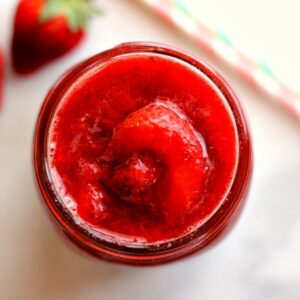 top down view of a jar of fresh strawberry sauce