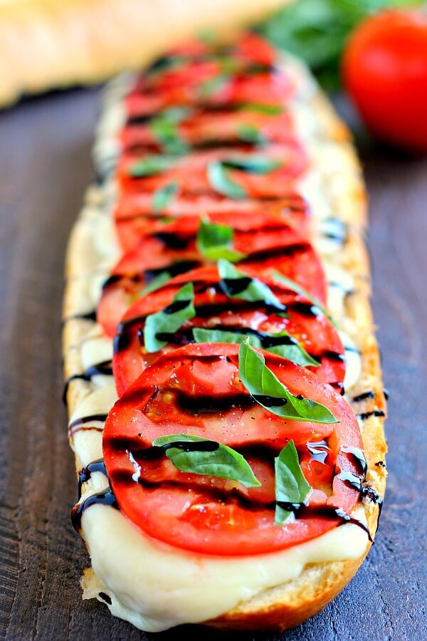 This Toasted Caprese Garlic Bread is made with hints of garlic and topped with ripe tomatoes, fresh basil, and creamy mozzarella cheese!