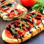 This Toasted Caprese Garlic Bread is made with hints of garlic and topped with ripe tomatoes, fresh basil, and creamy mozzarella cheese!