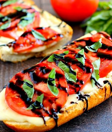 This Toasted Caprese Garlic Bread is made with hints of garlic and topped with ripe tomatoes, fresh basil, and creamy mozzarella cheese!