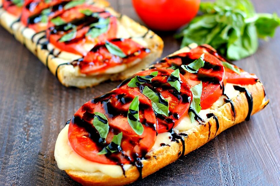 This Toasted Caprese Garlic Bread is made with hints of garlic and topped with ripe tomatoes, fresh basil, and creamy mozzarella cheese!