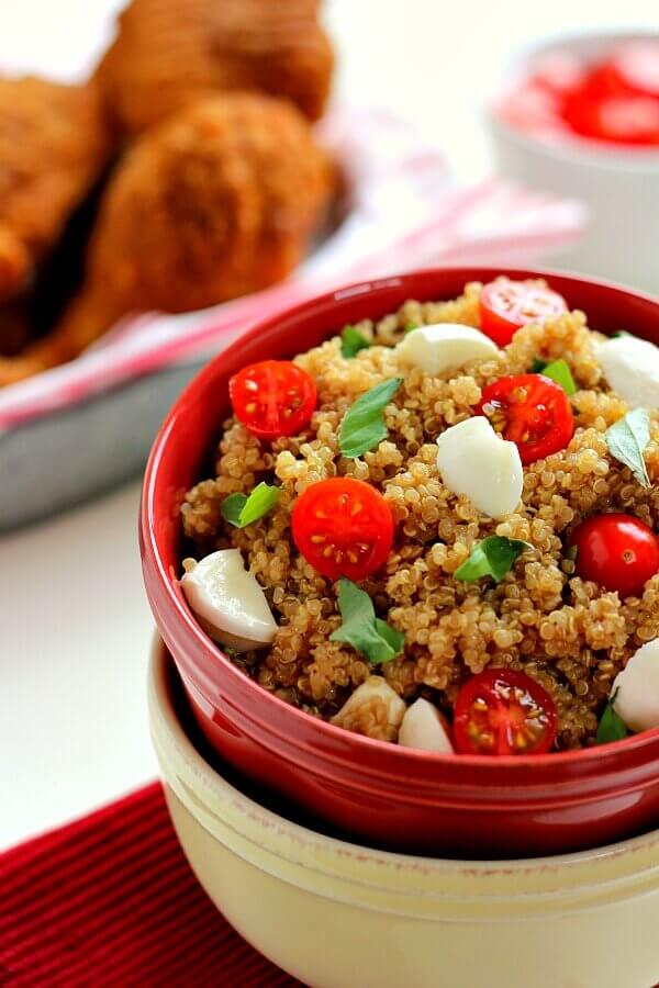 Filled with hearty quinoa, fresh tomatoes, creamy mozzarella, and basil, this Quinoa Caprese Salad combines the classic flavors into a healthier dish. It's easy to make, packed with protein, and is bursting with flavor! #quinoa #quinoasalad #quinoasaladrecipe #capresequinoa #capresesalad #capreserecipe #saladrecipe #easysalad #summersalad #sidedish #easysidedish