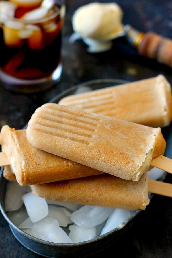 These Root Beer Float Popsicles taste just like the classic drink, but in frozen form! Filled with sweet root beer and creamy vanilla ice cream, these popsicles are the perfect treat to beat the heat!