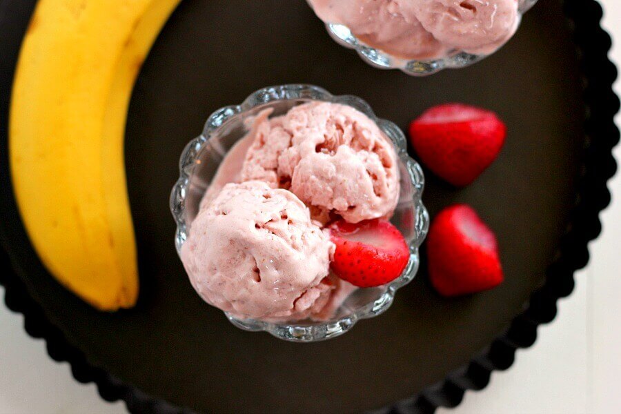 This Strawberry Banana Frozen Yogurt is creamy, packed with protein, and contains just four ingredients. It's also a fraction of the calories that you would find at frozen yogurt shop and tastes twice as good!