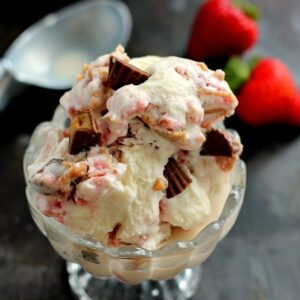 This Strawberry Peanut Butter Swirl Ice Cream is loaded with juicy strawberries and creamy peanut butter, swirled into sweet vanilla cream and then topped with peanut butter cups. And best of all, it's made without an ice cream maker!