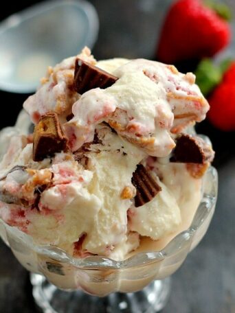 This Strawberry Peanut Butter Swirl Ice Cream is loaded with juicy strawberries and creamy peanut butter, swirled into sweet vanilla cream and then topped with peanut butter cups. And best of all, it's made without an ice cream maker!