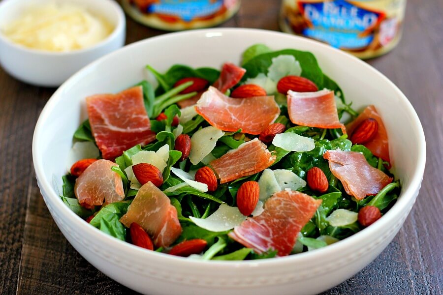 Packed with fresh arugula, salty prosciutto, roasted almonds and tossed in a light olive oil dressing, this Arugula and Prosciutto Almond Salad is light, refreshing and full of nutrients. It makes a delicious lunch on-the-go or a light dinner for those warm, summer nights!