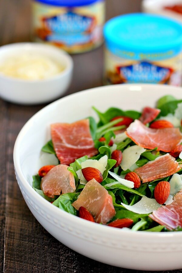 Packed with fresh arugula, salty prosciutto, roasted almonds and tossed in a light olive oil dressing, this Arugula and Prosciutto Almond Salad is light, refreshing and full of nutrients. It makes a delicious lunch on-the-go or a light dinner for those warm, summer nights!