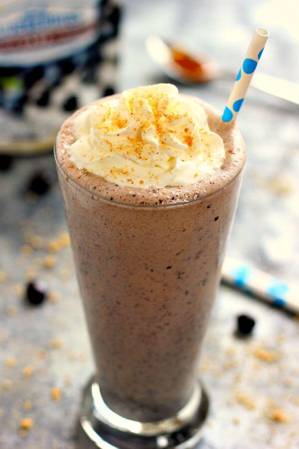 This Caramel Blueberry Milkshake is filled with sweet vanilla bean ice cream, rich caramel, and Dark Chocolate Blueberries from Brookside. It's creamy, delicious, and the perfect frozen treat to satisfy your ice cream cravings!