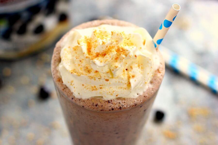 This Caramel Blueberry Pie Milkshake is filled with sweet vanilla bean ice cream, rich caramel, and Dark Chocolate Blueberries from Brookside. It's creamy, delicious, and the perfect frozen treat to satisfy your ice cream cravings!