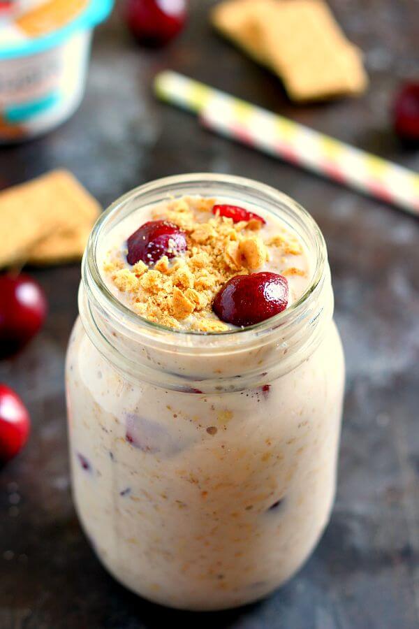 A mason jar filled with cherry overnight oats. 