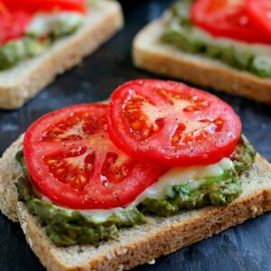 This Cheesy Guacamole Toast is loaded with creamy guacamole, mozzarella cheese, and fresh tomatoes. Full of flavor and healthy ingredients, this toast makes the perfect breakfast or mid-morning snack!