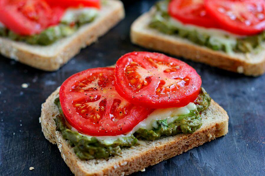 This Cheesy Guacamole Toast is loaded with creamy guacamole, mozzarella cheese, and fresh tomatoes. Full of flavor and healthy ingredients, this toast makes the perfect breakfast or mid-morning snack!