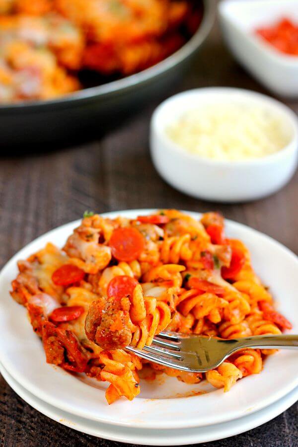 This One Pan Pizza Bake contains all of the classic pizza flavors packed into a one pan meal that is sure to satisfy your cravings. Filled with tender pasta, spicy sausage, lean pepperoni, and topped with cheese, this meal is sure to be a hit with everyone!
