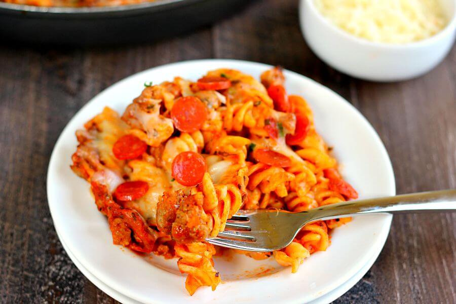 This One Pan Pizza Bake contains all of the classic pizza flavors packed into a one pan meal that is sure to satisfy your cravings. Filled with tender pasta, spicy sausage, lean pepperoni, and topped with cheese, this meal is sure to be a hit with everyone!