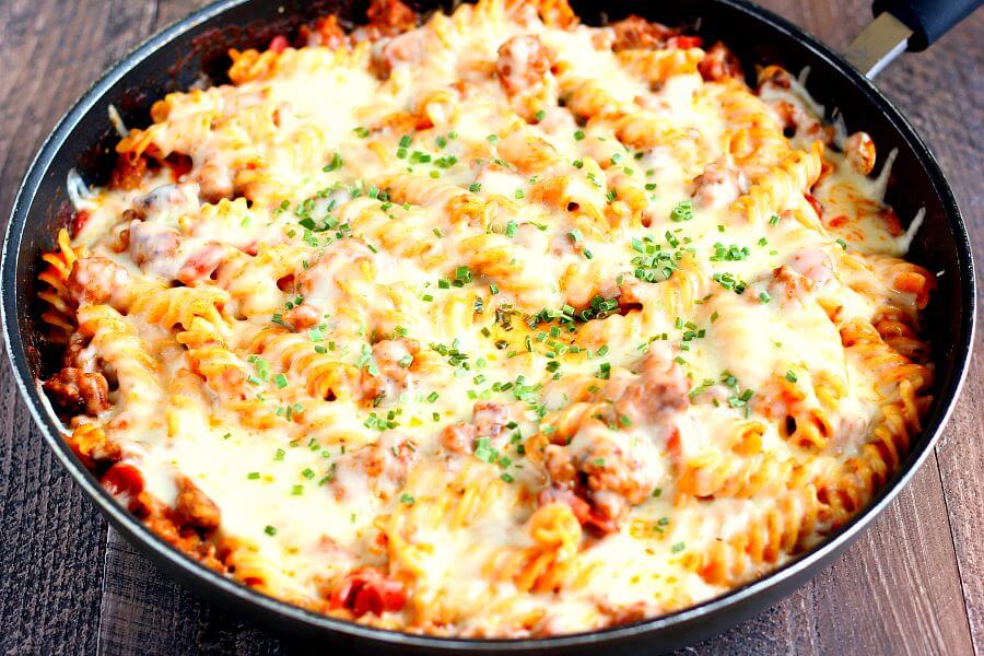This One Pan Pizza Bake contains all of the classic pizza flavors packed into a one pan meal that is sure to satisfy your cravings. Filled with tender pasta, spicy sausage, lean pepperoni, and topped with cheese, this meal is sure to be a hit with everyone!