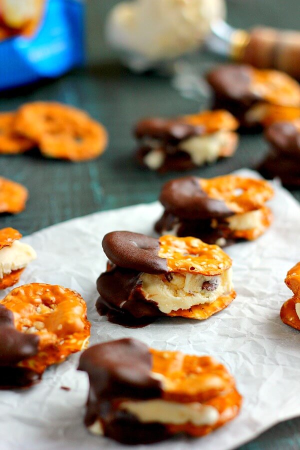 These Pretzel Ice Cream Bites are filled with peanut butter cup ice cream that is sandwiched between two Snack Factory Pretzel Crisps® and then dunked in chocolate. It's the perfect poppable, crunchy, and delicious treat!