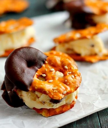 These Pretzel Ice Cream Bites are filled with peanut butter cup ice cream that is sandwiched between two Snack Factory Pretzel Crisps® and then dunked in chocolate. It's the perfect poppable, crunchy, and delicious treat!