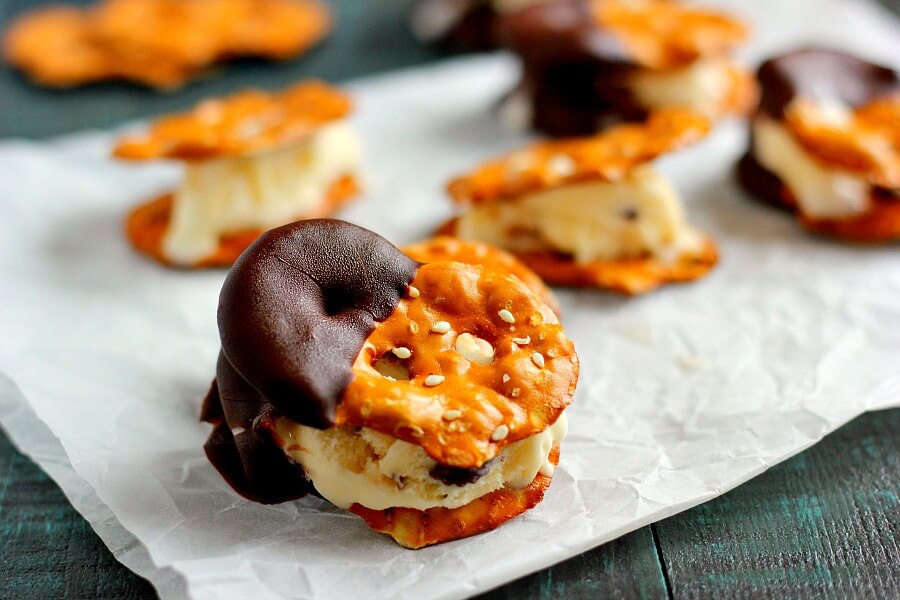 These Pretzel Ice Cream Bites are filled with peanut butter cup ice cream that is sandwiched between two Snack Factory Pretzel Crisps® and then dunked in chocolate. It's the perfect poppable, crunchy, and delicious treat!