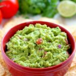 Filled with ripe avocados, fresh tomatoes, red onions, and spices, this Zesty Guacamole is jam-packed with flavor and ready to eat in just five minutes. It makes the perfect dip for chips, toppings for tacos and burritos, and spreads for sandwiches!