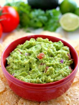 Filled with ripe avocados, fresh tomatoes, red onions, and spices, this Zesty Guacamole is jam-packed with flavor and ready to eat in just five minutes. It makes the perfect dip for chips, toppings for tacos and burritos, and spreads for sandwiches!