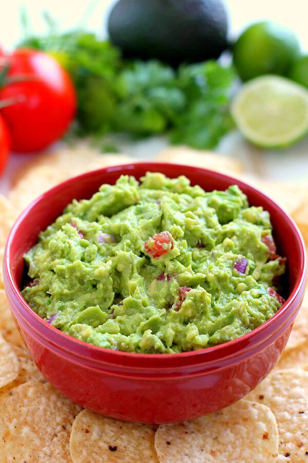 Filled with ripe avocados, fresh tomatoes, red onions, and spices, this Zesty Guacamole is jam-packed with flavor and ready to eat in just five minutes. It makes the perfect dip for chips, toppings for tacos and burritos, and spreads for sandwiches!