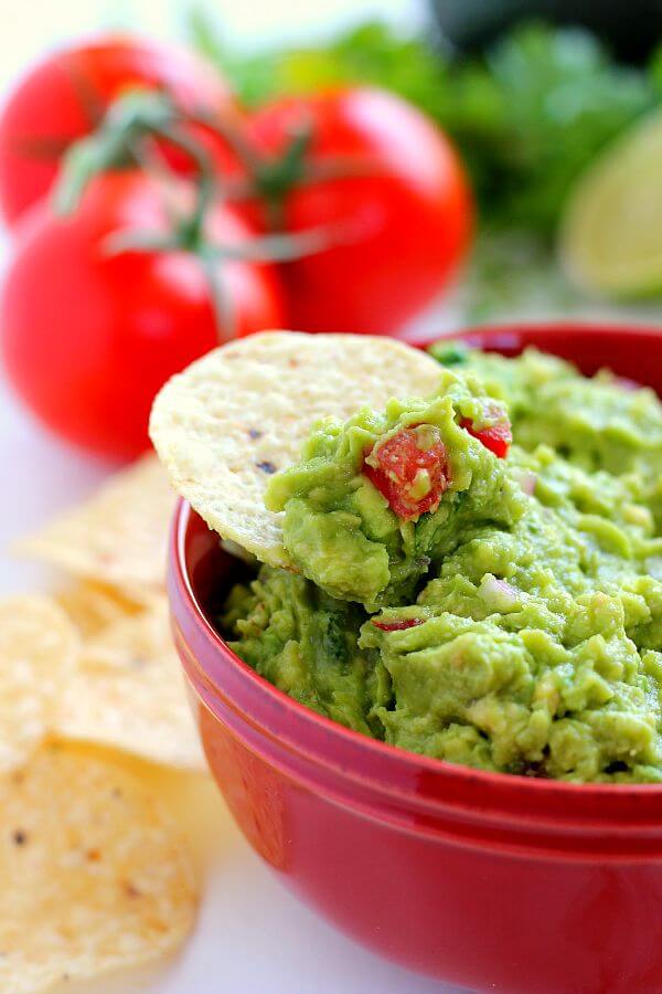 Filled with ripe avocados, fresh tomatoes, red onions, and spices, this Zesty Guacamole is jam-packed with flavor and ready to eat in just five minutes. It makes the perfect dip for chips, toppings for tacos and burritos, and spreads for sandwiches!