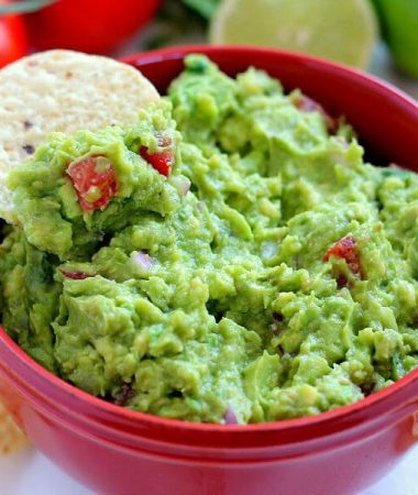 Filled with ripe avocados, fresh tomatoes, red onions, and spices, this Zesty Guacamole is jam-packed with flavor and ready to eat in just five minutes. It makes the perfect dip for chips, toppings for tacos and burritos, and spreads for sandwiches!