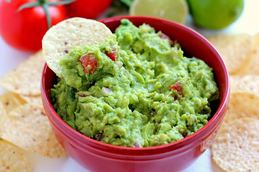 Filled with ripe avocados, fresh tomatoes, red onions, and spices, this Zesty Guacamole is jam-packed with flavor and ready to eat in just five minutes. It makes the perfect dip for chips, toppings for tacos and burritos, and spreads for sandwiches!