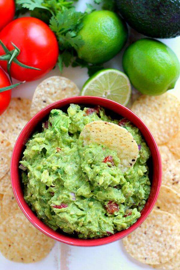 Filled with ripe avocados, fresh tomatoes, red onions, and spices, this Zesty Guacamole is jam-packed with flavor and ready to eat in just five minutes. It makes the perfect dip for chips, toppings for tacos and burritos, and spreads for sandwiches!