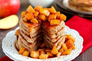 apple cinnamon pancakes with a slice cut out