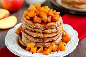 pancakes with apple cinnamon topping on a white plate