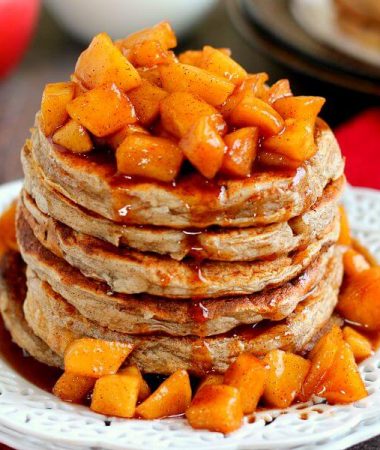 pancakes with apple cinnamon topping on a white plate