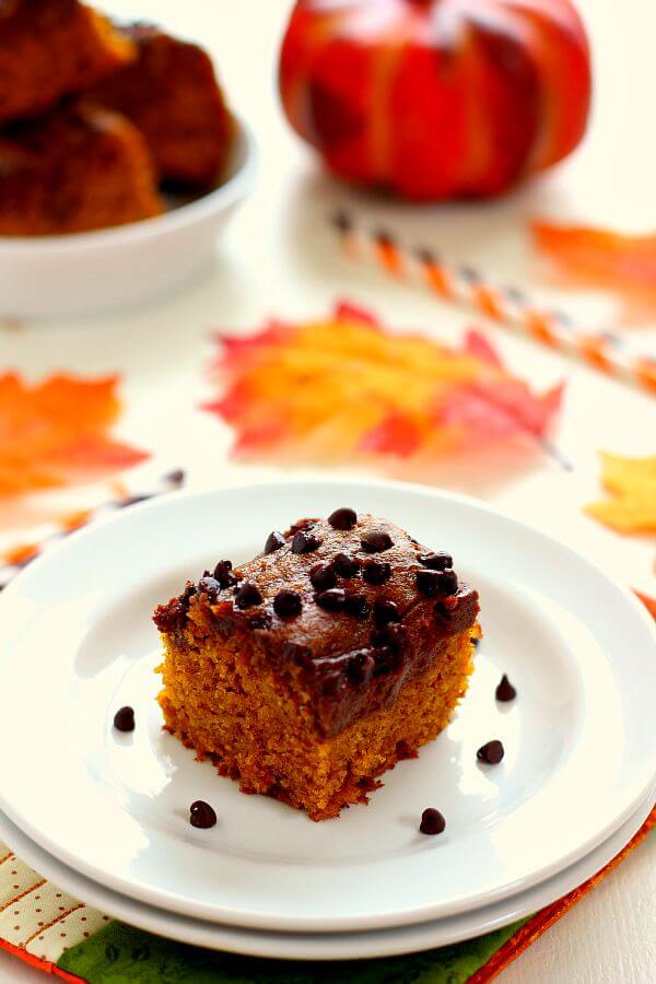 These Chocolate-Swirled Pumpkin Bars are soft, moist, and bursting with flavor. The pumpkin cake is filled with hints of cinnamon and spices and swirled with a chocolate cream cheese mixture! #pumpkin #pumpkinbars #pumpkinbarrecipe #pumpkincake #pumpkincakerecipe #creamcheesefrosting #chocolatefrosting #chocolatecreamcheesefrosting #pumpkinrecipe #falldessert #fallrecipe #falldessertrecipe
