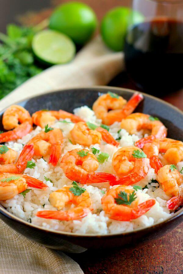 This Honey Garlic Shrimp and Cilantro Lime Rice Bowl is packed with tender shrimp, seasoned with a sweet honey garlic sauce and nestled on top of zesty cilantro lime rice. It's ready in just 20 minutes and bursting with flavor!