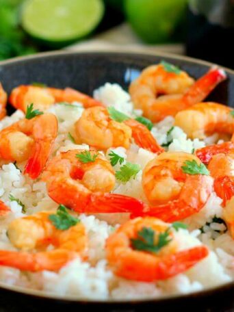 This Honey Garlic Shrimp and Cilantro Lime Rice Bowl is packed with tender shrimp, seasoned with a sweet honey garlic sauce and nestled on top of zesty cilantro lime rice. It's ready in just 20 minutes and bursting with flavor!