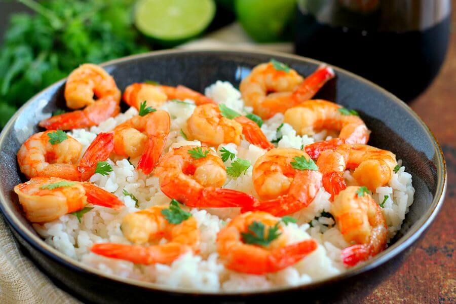 This Honey Garlic Shrimp and Cilantro Lime Rice Bowl is packed with tender shrimp, seasoned with a sweet honey garlic sauce and nestled on top of zesty cilantro lime rice. It's ready in less than 30 minutes and bursting with flavor!