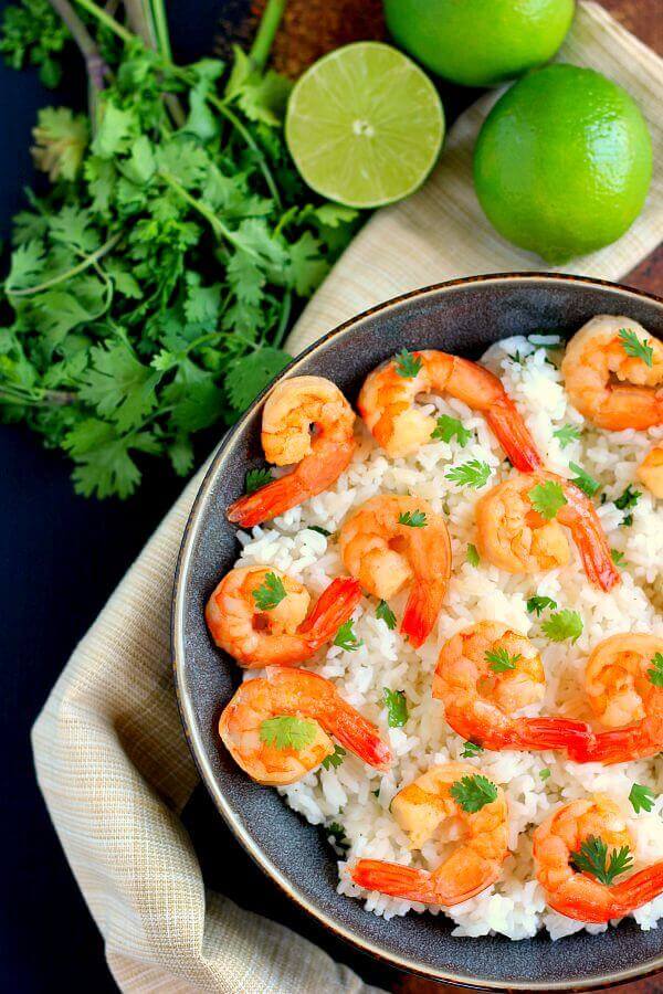 This Honey Garlic Shrimp and Cilantro Lime Rice Bowl is packed with tender shrimp, seasoned with a sweet honey garlic sauce and nestled on top of zesty cilantro lime rice. It's ready in less than 30 minutes and bursting with flavor!