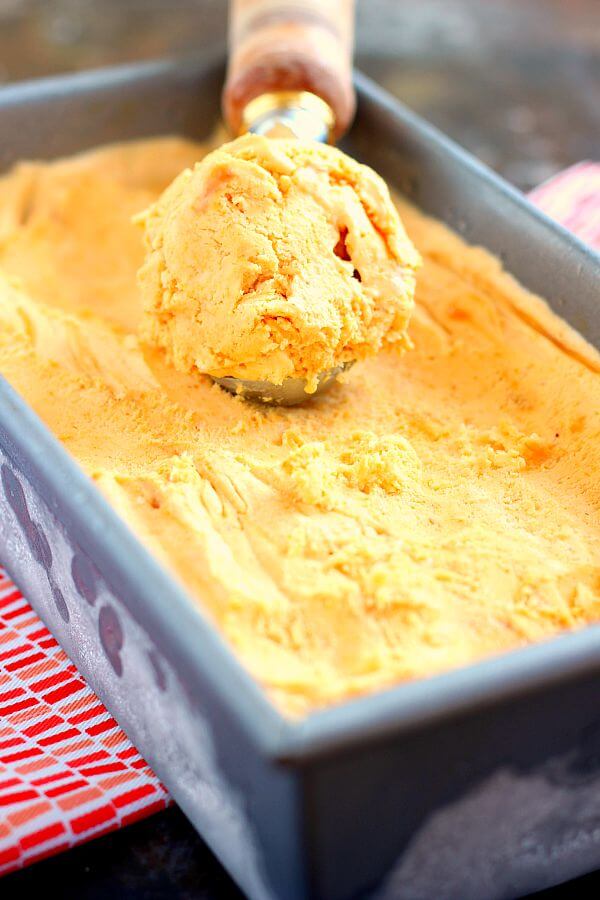 This Pumpkin Caramel Ice Cream is a no-churn recipe and is filled with a smooth pumpkin flavor. It's creamy, swirled with caramel, and so easy to make. If you like pumpkin, then this frozen treat was made for you! #icecream #icecreamrecipe #pumpkinicecream #pumpkinicecreamrecipe #nochurnicecream #nochurnrecipe #caramelicecream #dessert #falldessert #fallrecipe