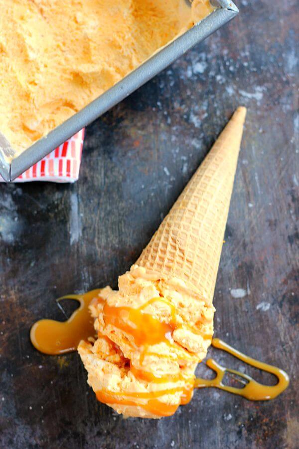 This Pumpkin Caramel Ice Cream is a no-churn recipe and is filled with a smooth pumpkin flavor. It's creamy, swirled with caramel, and so easy to make. If you like pumpkin, then this frozen treat was made for you! #icecream #icecreamrecipe #pumpkinicecream #pumpkinicecreamrecipe #nochurnicecream #nochurnrecipe #caramelicecream #dessert #falldessert #fallrecipe