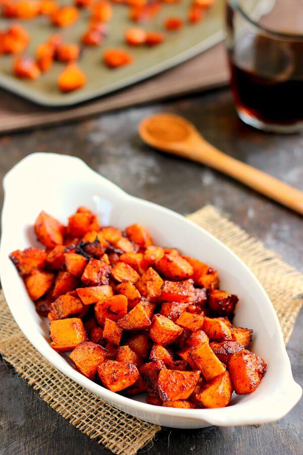 maple cinnamon roasted sweet potatoes in a white dish