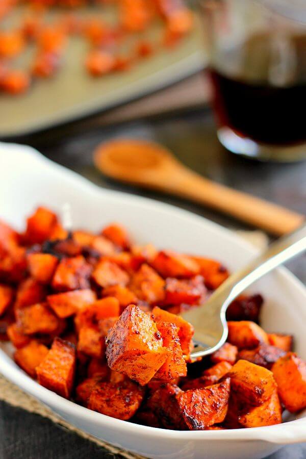 closeup of a forkful of cinnamon maple roasted sweet potatoes